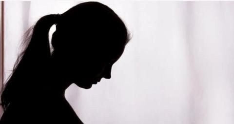 A shadow of a woman victim of domestic violence