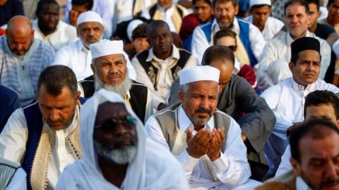 ibyan Muslims perform the Eid Al-Adha morning prayer at the Martyrs Square of the capital Tripoli on August 11, 2019. -