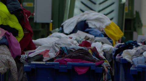 Bins of clothes in a warehouse 