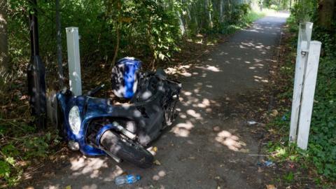 Abandoned motorcycle on a footpath