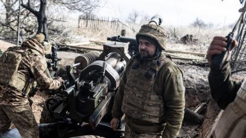 Ukrainian soldiers wait for orders next to L119 artillery, as Russia-Ukraine war continues in the direction of Mariinka, Donetsk Oblast, Ukraine, 23 February 2024
