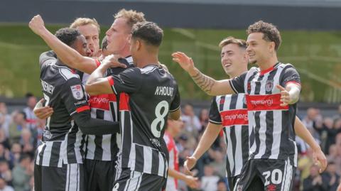 Grimsby Town players celebrate a goal