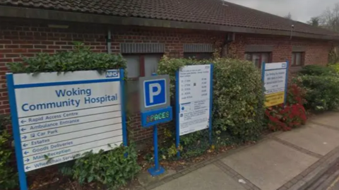 Signs at the entrance to Woking Community Hospital