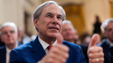 FILE PHOTO: Texas Governor Greg Abbott gives the thumbs up during the signing event for an executive order to shut down the Department of Education by U.S. President Donald Trump, in the East Room at the White House in Washington, DC, US, 20 March, 2025. REUTERS/Carlos Barria/File Photo.