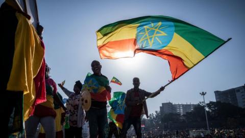 A man flying the Ethiopian flag