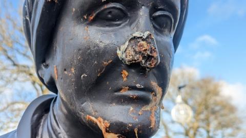 Close up of damaged figure with nose missing