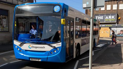 A blue and white bus in Exeter, near the bus station.