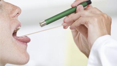 A woman having her throat checked