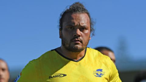 Pouri Rakete-Stones in a yellow training t-shirt for current team Hurricanes