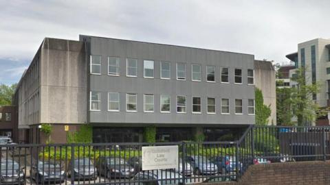 A Google Street View image of the court, a concrete building with more modern cladding at the front.
