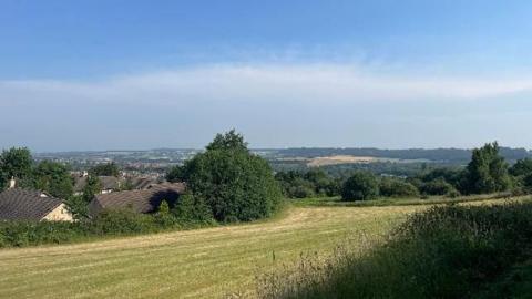 A view of green fields and rolling hills