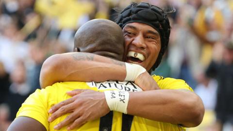 La Rochelle centre Ulupano Seuteni congratulates his team-mate Raymond Rhule after he scores a try