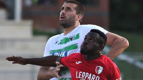 TNS' Ryan Astles battles with Swift Hesper's Paul Ayongo