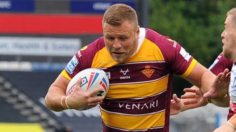 Huddersfield's Josh Jones powers toward the line against Warrington in 2022
