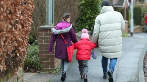 schoolchildren make their way to primary school