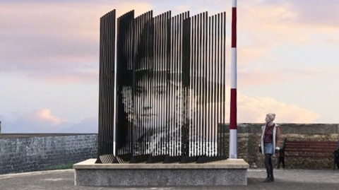 Proposed sculpture of 'lost girl' for Aberaeron harbour, with an image of Mary. A woman is standing by it