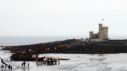 People walking to the Tower of Refuge