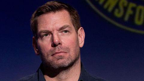 Eric Swalwell wears a dark blue button down shirt at a candidate forum in Los Angeles last year.