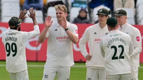 Dillon Pennington celebrates with his Notttinghamshire team-mates after taking a wicket against Lancashire