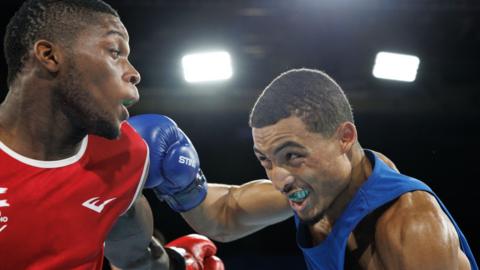 Orlando Holley-Sotomi lands a punch on opponent Refiloe Thai.