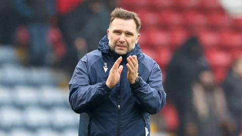 Blackburn Rovers boss John Eustace clapping the fans after the match