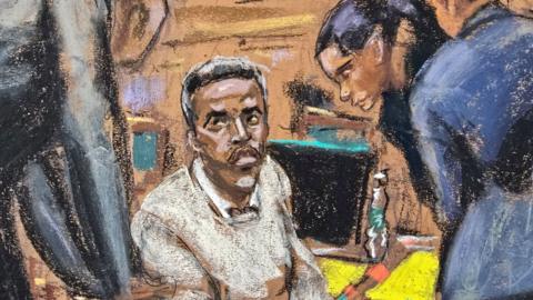 Sean 'Diddy' Combs is surrounded by legal counsel in a court sketch. His face is serious.