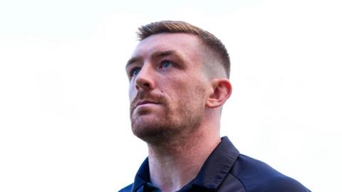 Ed Chamberlain, looking upwards, wearing training gear ahead of