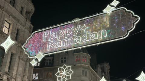 Festive lighting hung in central London with the wording Happy Ramadan.