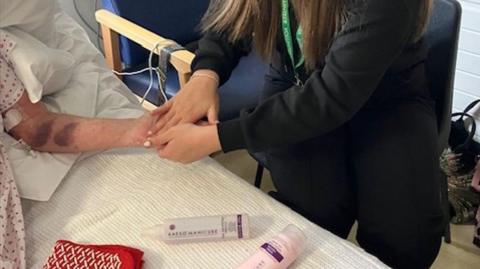 Student giving a patient a massage