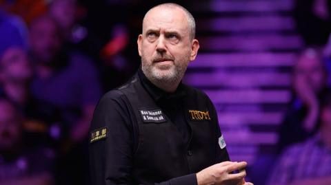 Mark J Williams of Wales chalks the cue