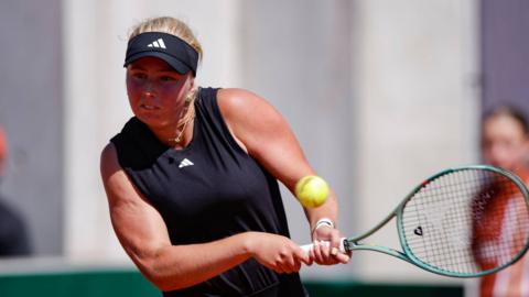 Clara Tauson of Denmark returns a backhand