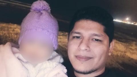 Eddie Santos and the blurred face of one of his children
