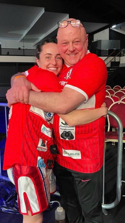 Jade Pearce being hugged by her dad John