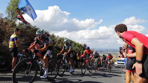 Cyclists climb a hill during the Tour of Britain