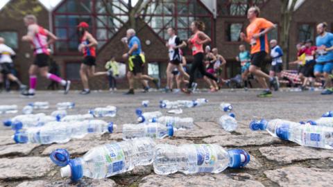 Discarded plastic bottles on the side of a marathon course 
