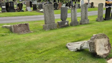 Overturned gravestones in a cemetery 