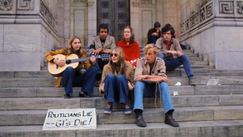 A group of protesters sit on New York City library