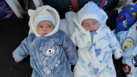 Twins Mahdi and Hammoudi wearing onesis and hats