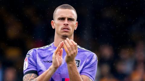 Newport County goalkeeper Nik Tzanev applauds the fans
