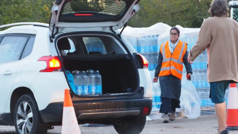 Customers being given bottled water after a water outage in Guildford