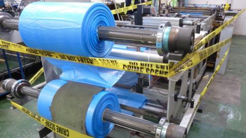 Machine surrounded in yellow police tape