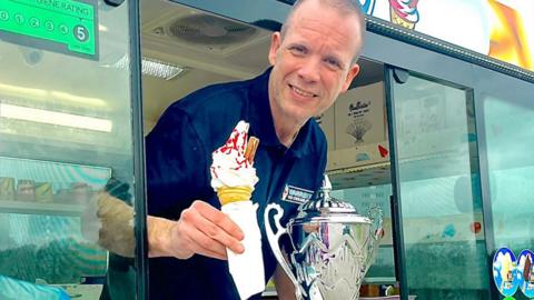Warren Dickens with Ice Cream in his van with Trophy