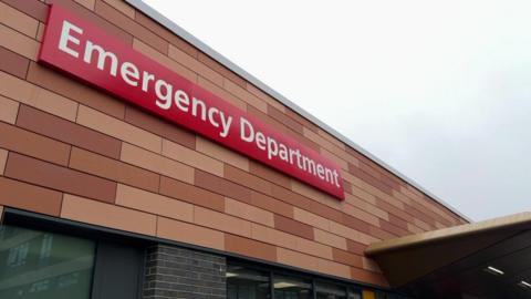 The outside of the new emergency department showing the brown bricklike cladding and the canopy.