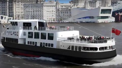 A computer generated image shows the red, black and white vessel sailing on the River Mersey, with two large decks seen and people on the lower deck. There are a number of windows, including some larger windows. The Liver Building and the Museum of Liverpool can be seen in the background.