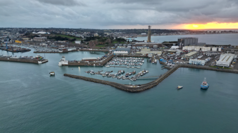 An aerial view of Jersey's main harbour at sunset.
