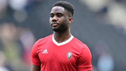 Junior Luamba warming up for a Salford game