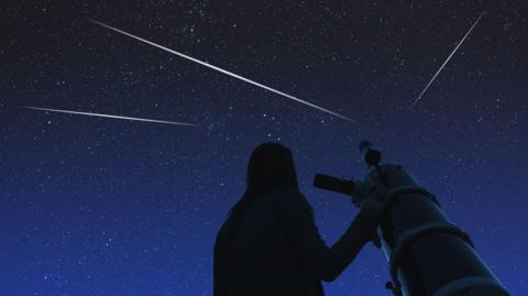 girl with telescope stargazing