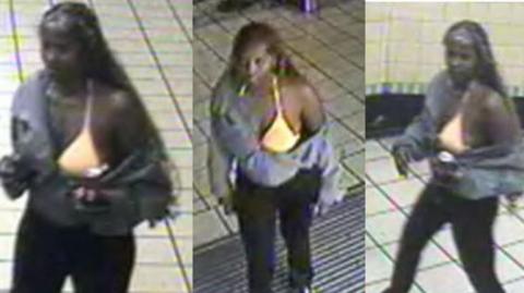 A blurred CCTV image of a woman in a London underground station who is wearing dark trousers, a bright yellow bikini top and a grey hoodie. 