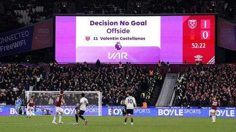 The big screen shows a VAR decision to disallow a West Ham goal for offside