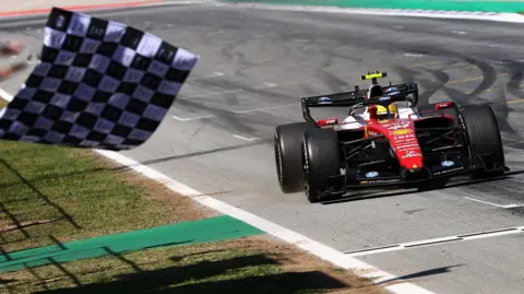 The chequered flag is waved as Lewis Hamilton crosses the line to win the Barcelona-Catalunya Grand Prix